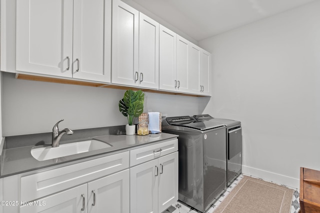 laundry room with washer and dryer, sink, and cabinets