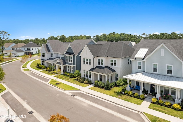 3836 Mason Port Dr, Wilmington, NC 28409 - view of front of house with a standing seam roof, a residential view, a metal roof, covered porch, and a shingled roof