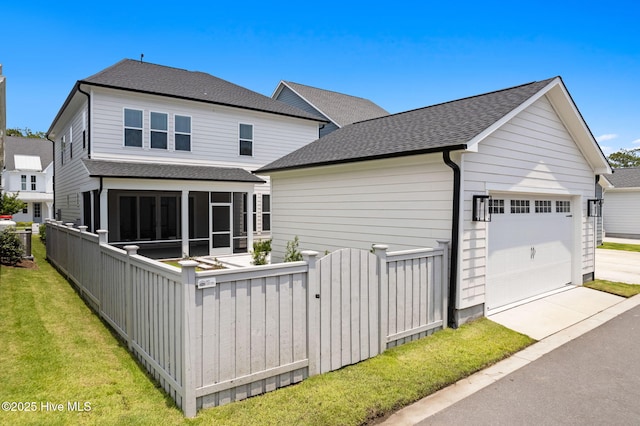 3836 Mason Port Dr, Wilmington, NC 28409 - back of house with a sunroom, roof with shingles, and a gate