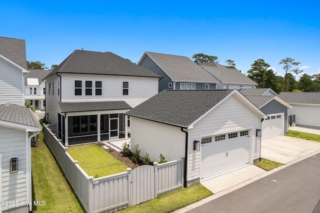 3836 Mason Port Dr, Wilmington, NC 28409 - traditional-style home featuring a fenced backyard, a sunroom, roof with shingles, and a gate