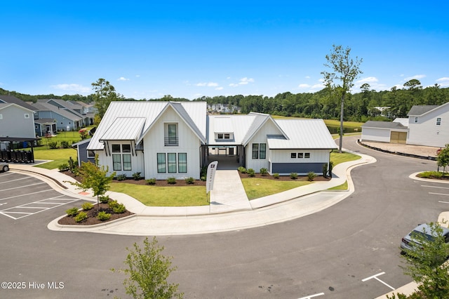3836 Mason Port Dr, Wilmington, NC 28409 - modern inspired farmhouse featuring board and batten siding, uncovered parking, a front lawn, and a metal roof