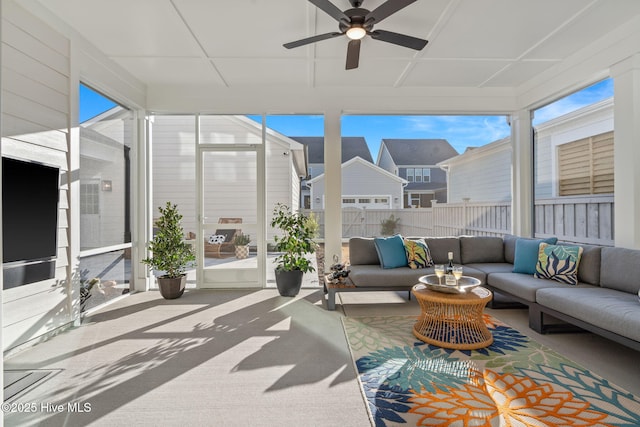 sunroom featuring ceiling fan and a healthy amount of sunlight