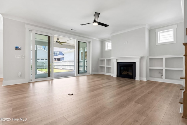 3836 Mason Port Dr, Wilmington, NC 28409 - unfurnished living room with ceiling fan, crown molding, a glass covered fireplace, and light wood-type flooring