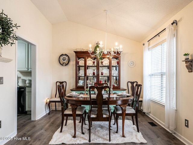 dining space featuring vaulted ceiling, dark wood-type flooring, and a notable chandelier