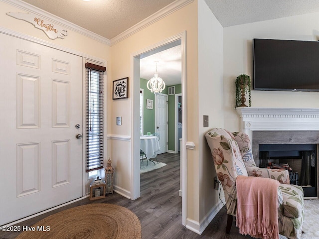 foyer entrance featuring a healthy amount of sunlight, dark wood-type flooring, and a textured ceiling