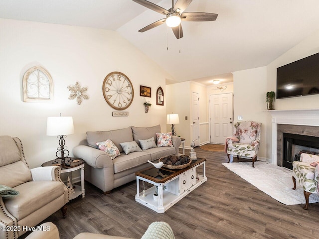 living room featuring vaulted ceiling, dark hardwood / wood-style floors, and ceiling fan