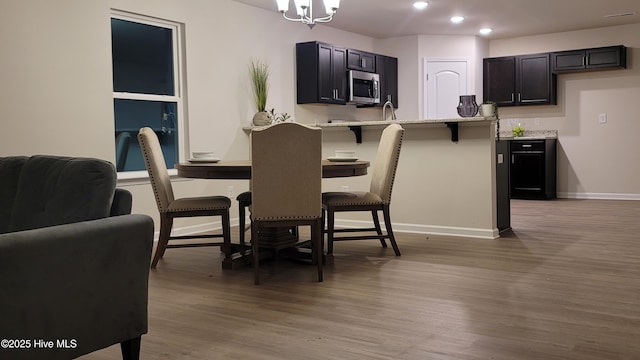 dining space with an inviting chandelier and hardwood / wood-style floors