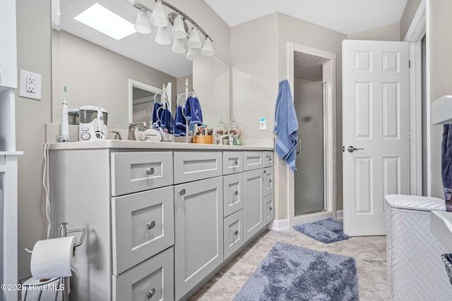 bathroom featuring a skylight, vanity, and walk in shower