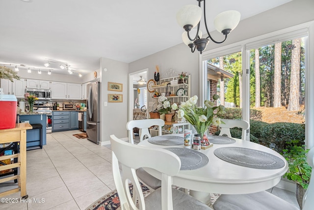 dining room featuring an inviting chandelier and light tile patterned floors