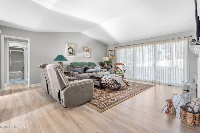 living room with lofted ceiling and light hardwood / wood-style floors