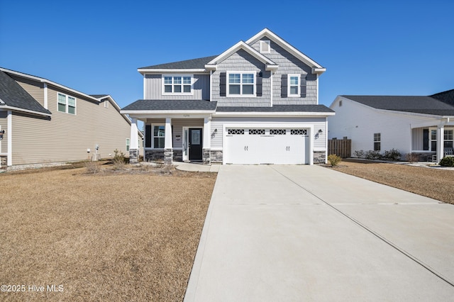 craftsman house with a garage, a front lawn, and covered porch