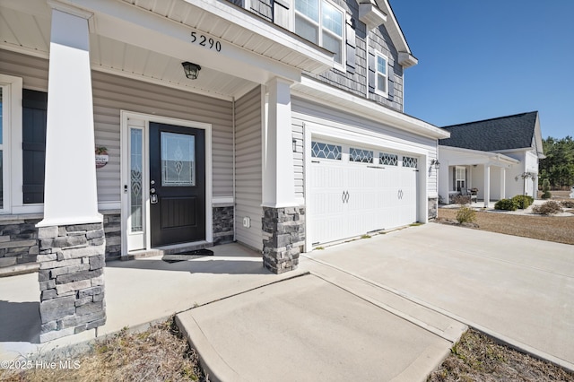 view of exterior entry with a garage