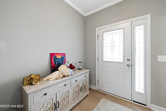 entryway with ornamental molding, plenty of natural light, and light hardwood / wood-style flooring