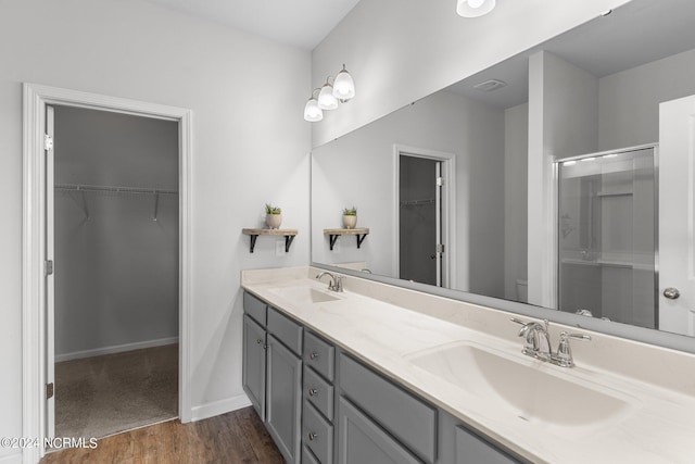 bathroom with vanity, toilet, an enclosed shower, and hardwood / wood-style floors