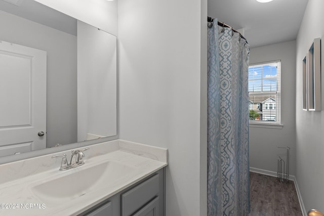 bathroom featuring hardwood / wood-style flooring, vanity, and a shower with shower curtain