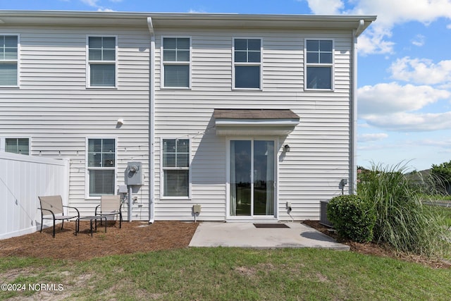 rear view of house featuring a patio area and a lawn