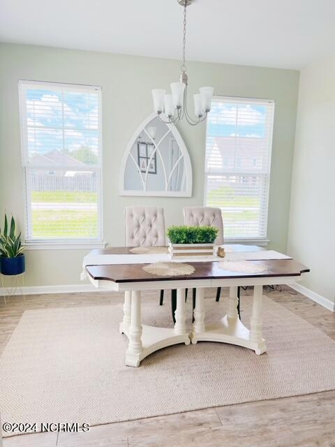 dining space featuring a wealth of natural light, hardwood / wood-style floors, and breakfast area