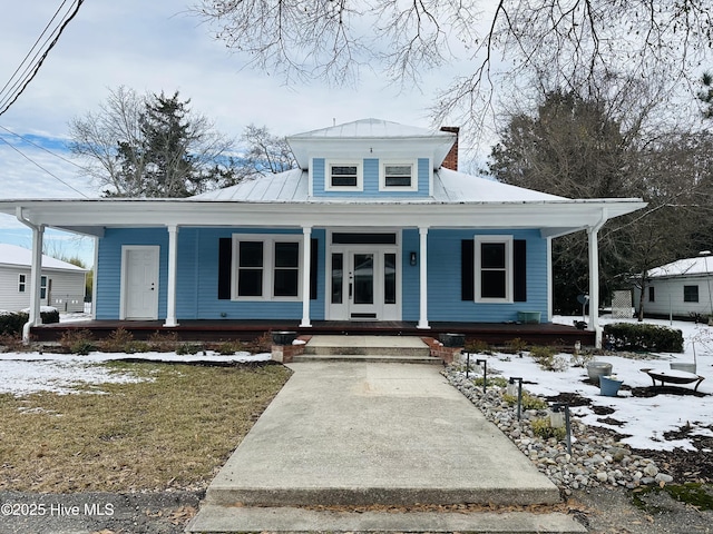 bungalow-style home featuring a yard and covered porch