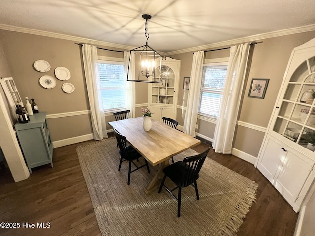 dining space with crown molding, dark hardwood / wood-style floors, and a wealth of natural light