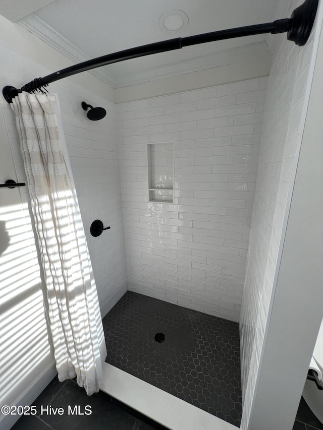 bathroom with tile patterned floors, ornamental molding, and curtained shower