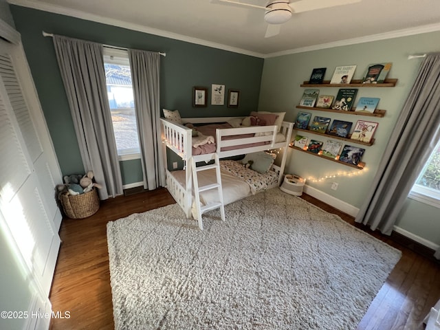 bedroom with dark wood-type flooring, ceiling fan, and ornamental molding