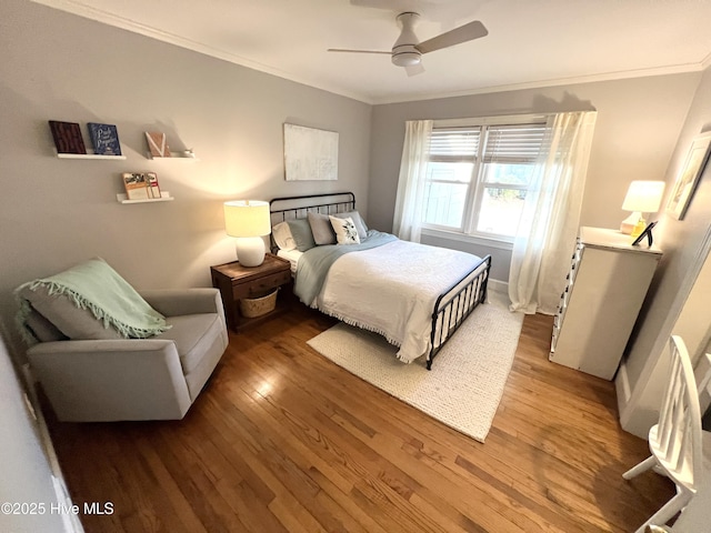 bedroom featuring crown molding, ceiling fan, and wood-type flooring