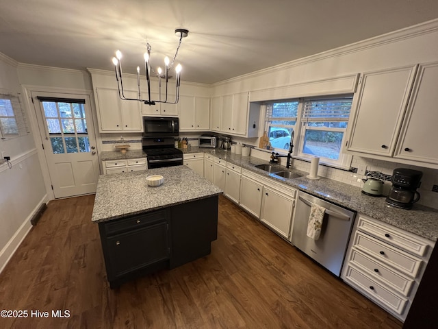 kitchen featuring sink, white cabinetry, hanging light fixtures, a kitchen island, and black appliances