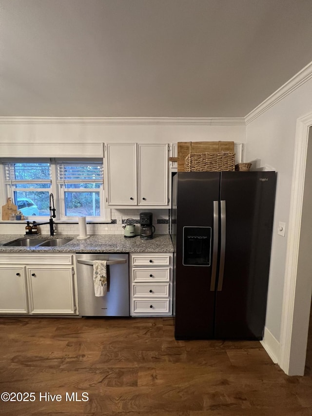 kitchen with stone counters, appliances with stainless steel finishes, dark hardwood / wood-style floors, white cabinetry, and sink