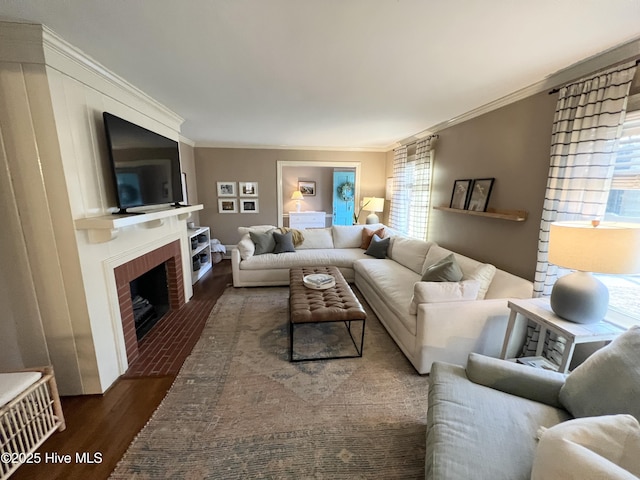 living room with dark hardwood / wood-style flooring, a brick fireplace, and ornamental molding