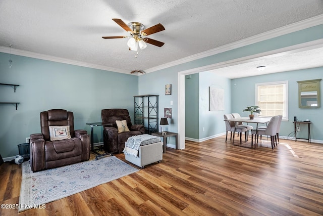 living room with ceiling fan, crown molding, dark hardwood / wood-style floors, and a textured ceiling