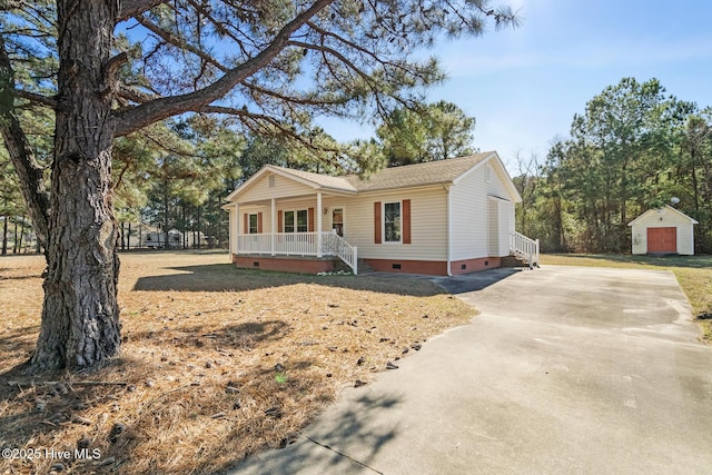 view of front of property featuring a storage unit and covered porch