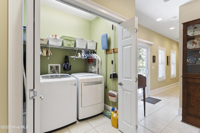 laundry room with light tile patterned floors and washer and dryer