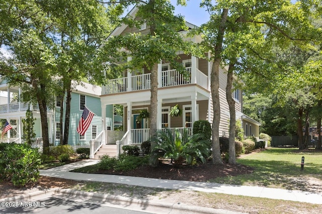 view of front of property with a balcony and a porch