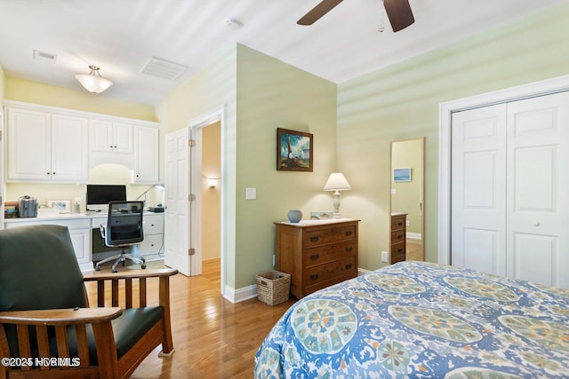 bedroom featuring ceiling fan, light wood-type flooring, and a closet