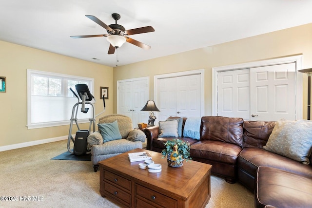 carpeted living room with ceiling fan