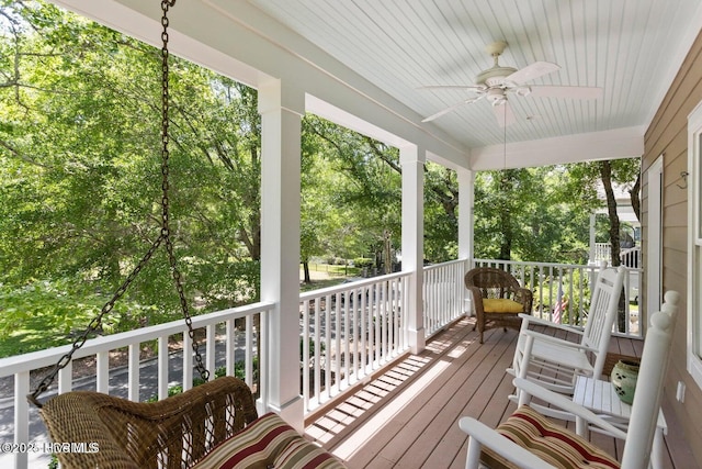 sunroom / solarium featuring ceiling fan