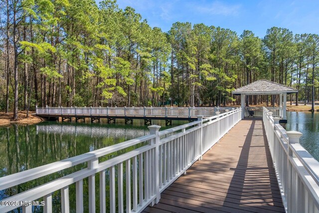 view of dock with a gazebo and a water view