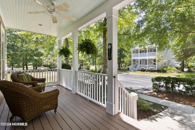 wooden terrace with ceiling fan and covered porch