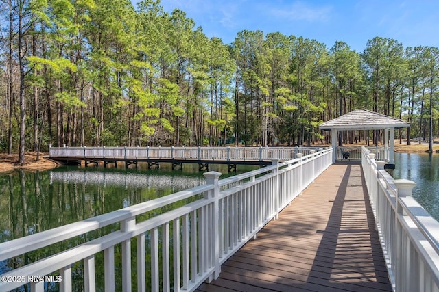 view of dock featuring a gazebo and a water view