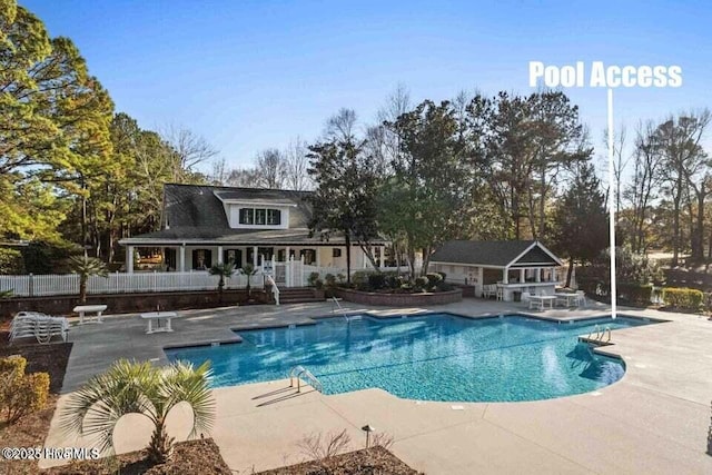 view of swimming pool with an outbuilding and a patio area