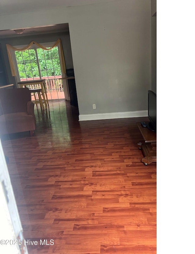 unfurnished living room featuring hardwood / wood-style floors