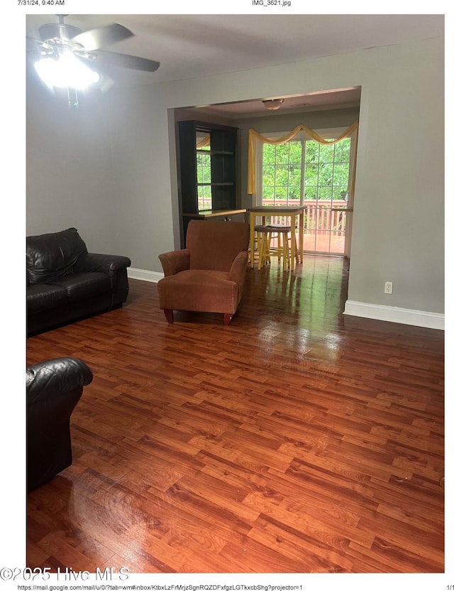 living room with hardwood / wood-style floors and ceiling fan