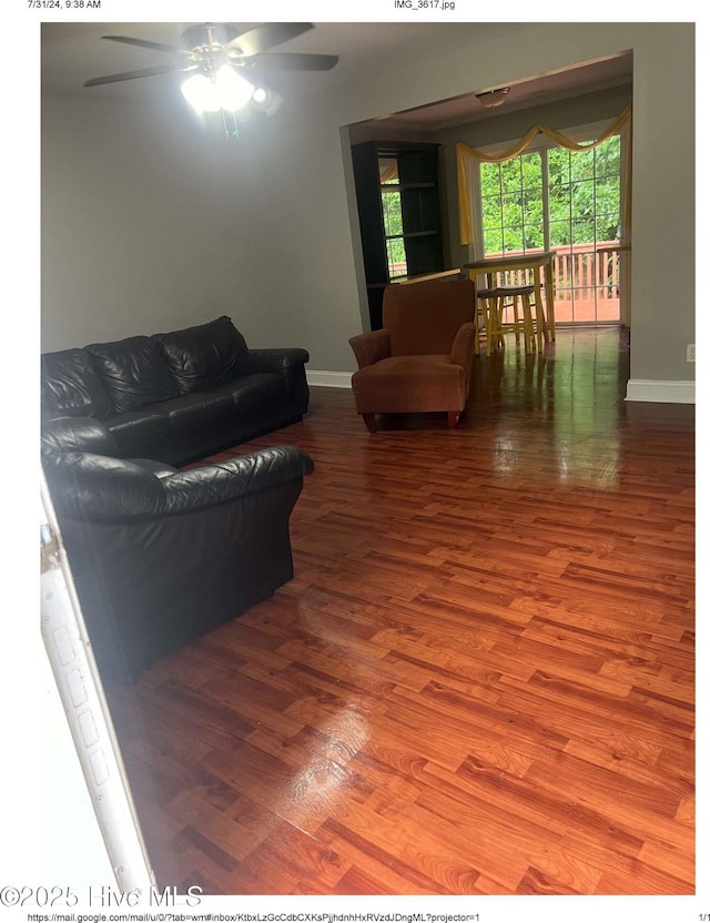 living room with hardwood / wood-style flooring and ceiling fan