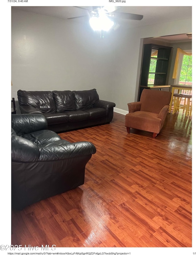 living room featuring hardwood / wood-style floors and ceiling fan