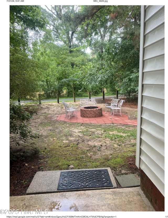 view of yard with a patio and a fire pit