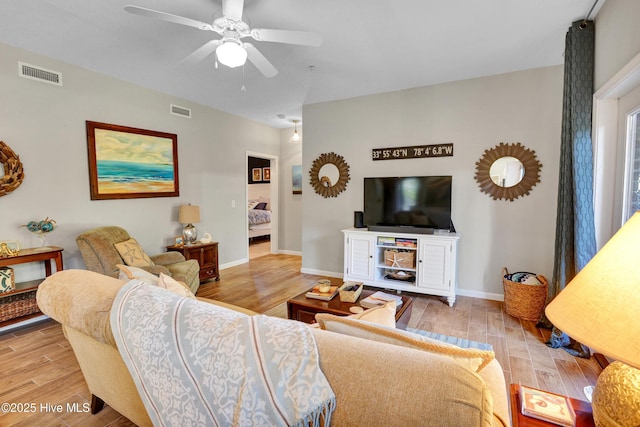 living room featuring ceiling fan and light wood-type flooring