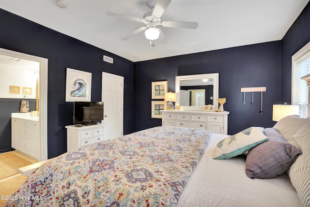 bedroom with ceiling fan and ensuite bath