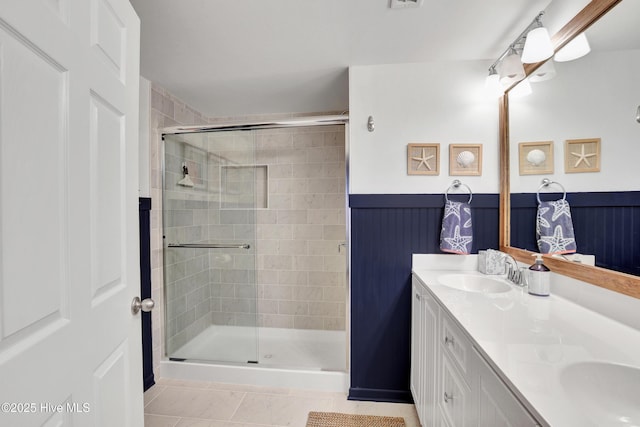 bathroom featuring an enclosed shower, vanity, and tile patterned floors