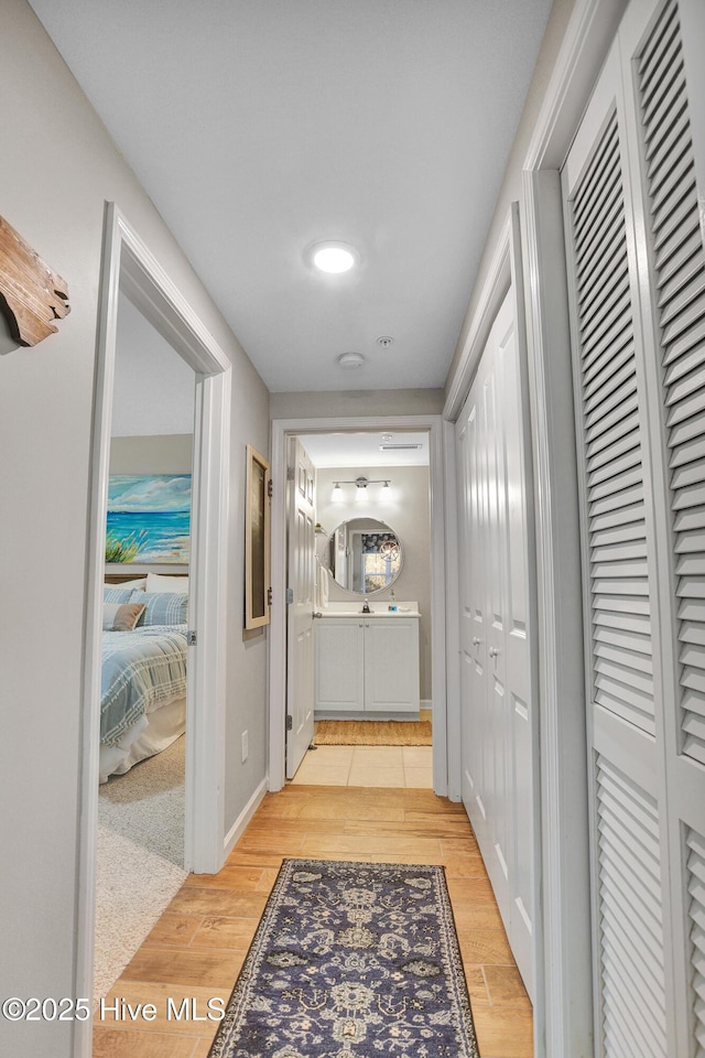 hallway with light hardwood / wood-style flooring