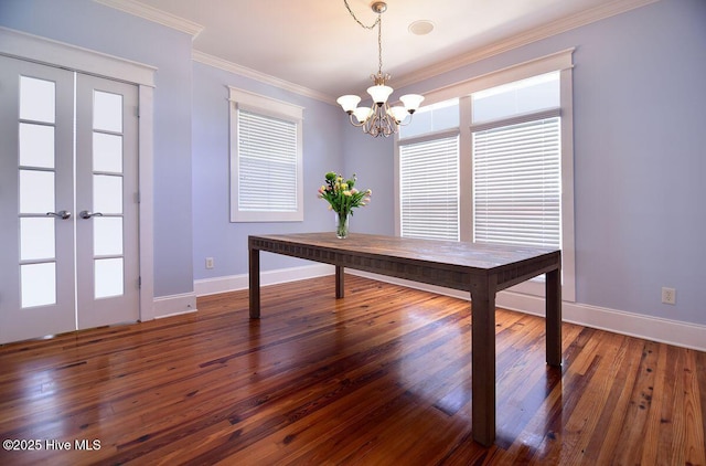 unfurnished office with an inviting chandelier, dark wood-type flooring, ornamental molding, and french doors